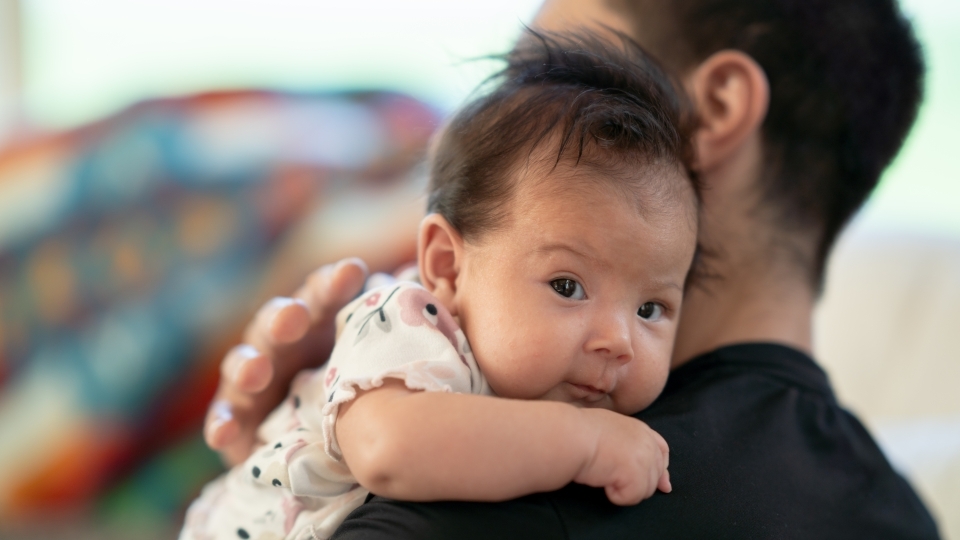 Baby on father's shoulder