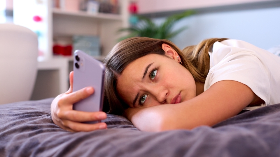 Teen sadly scrolling social media