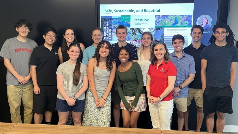 a group of students and adults together in a conference room