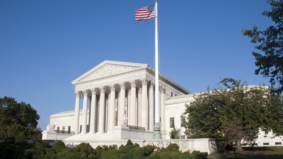 Supreme Court Building will American flag in front