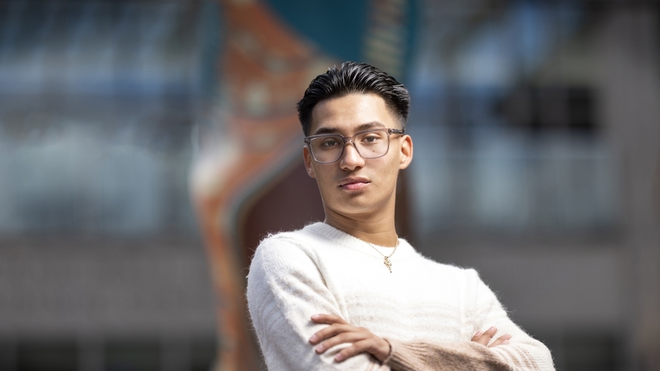 a young man with glasses and black hair