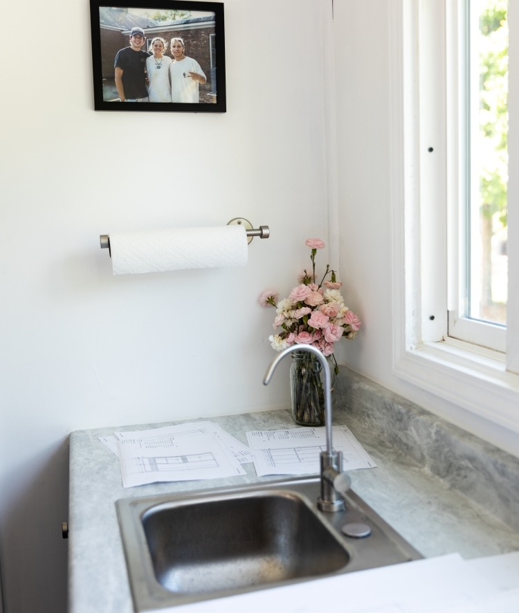 Interior of kitchen with countertops, paper towels, and sink