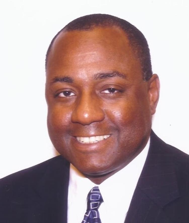 an older Black man wearing a suit and tie
