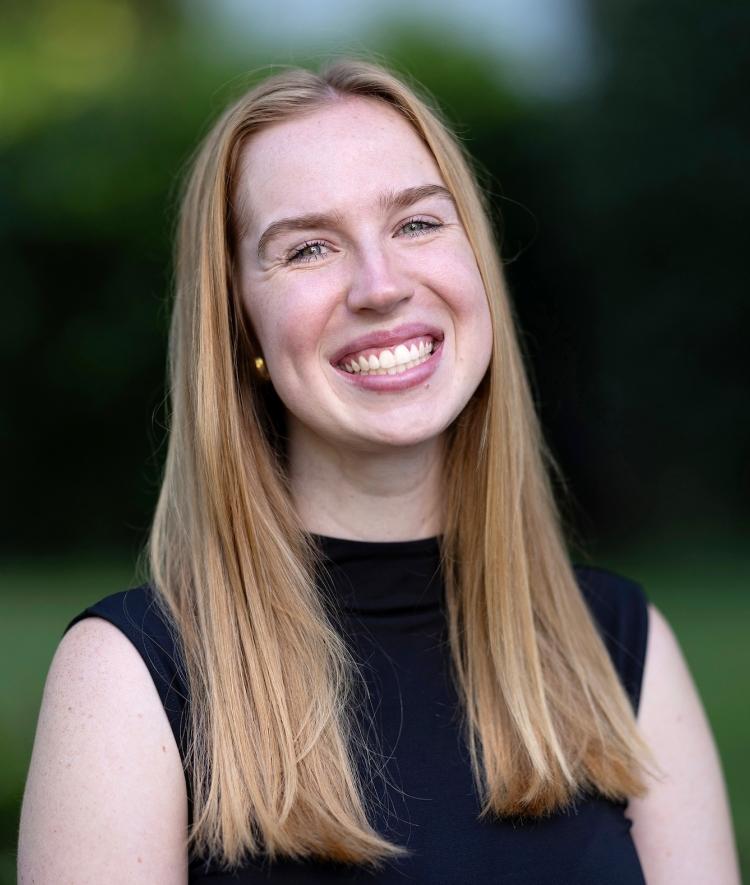 a young white woman wearing black and smiling