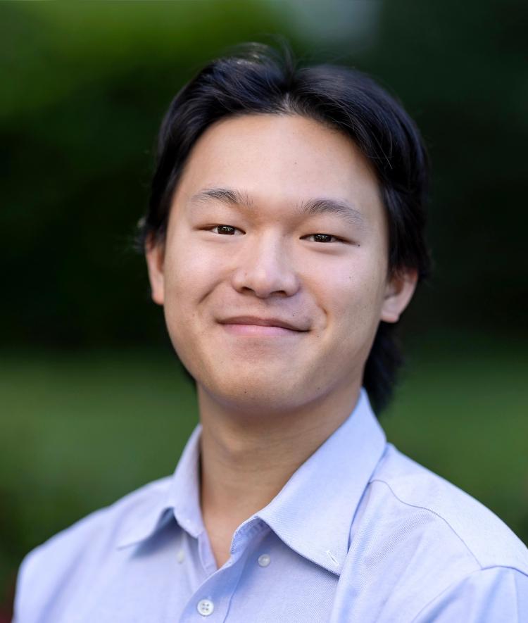 a young Asian man wearing a collared shirt