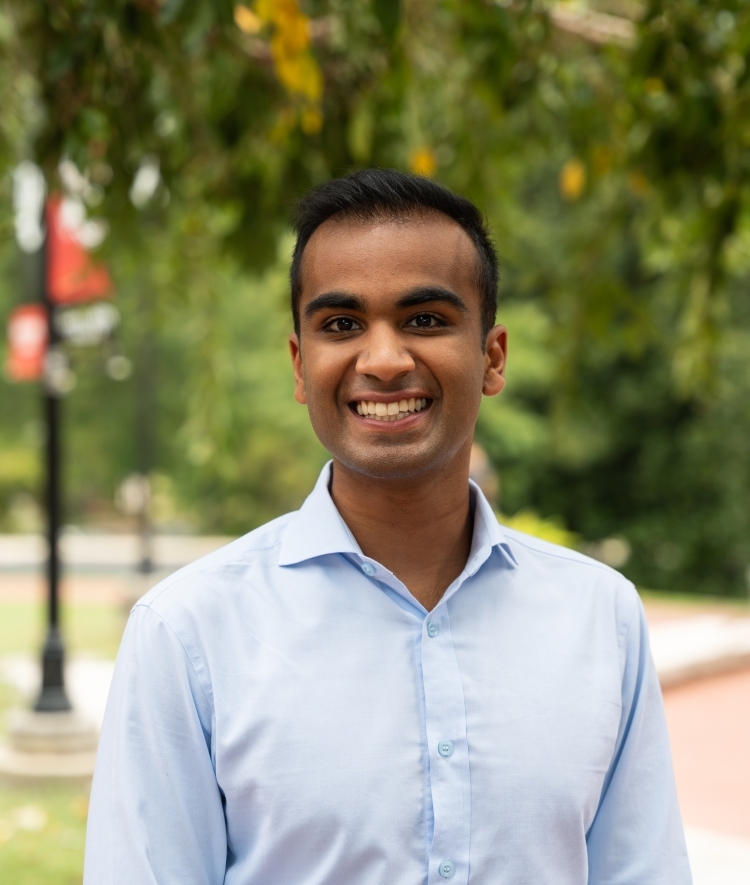 a young man wearing a blue collared shirt