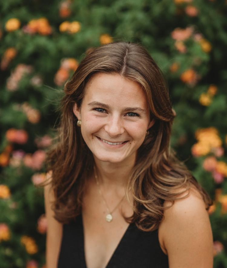 a young white woman with brown hair smiles