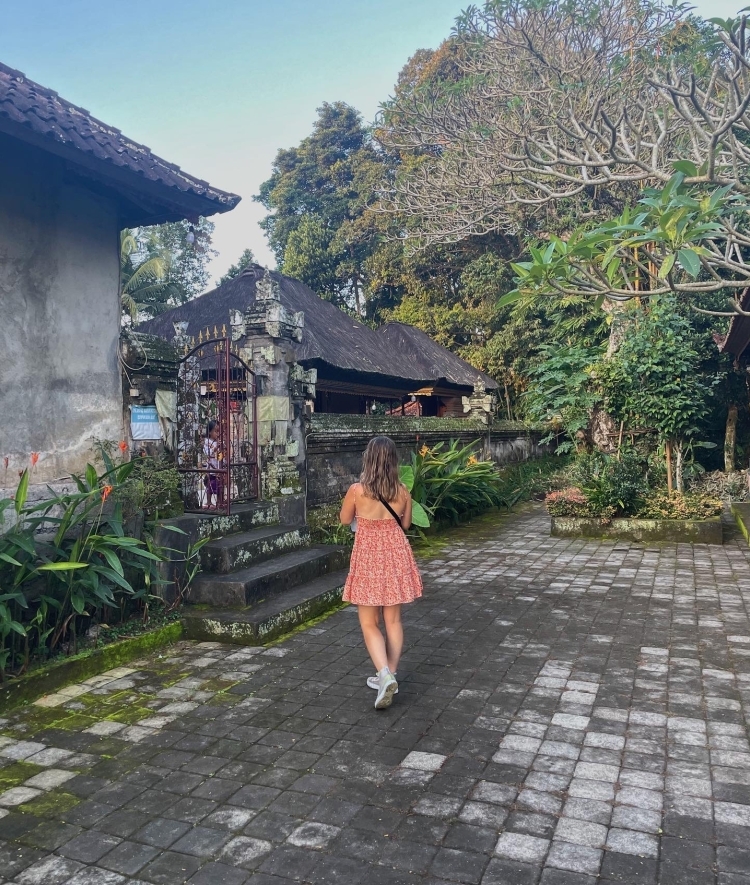 a young woman walks through a scene in East Asia