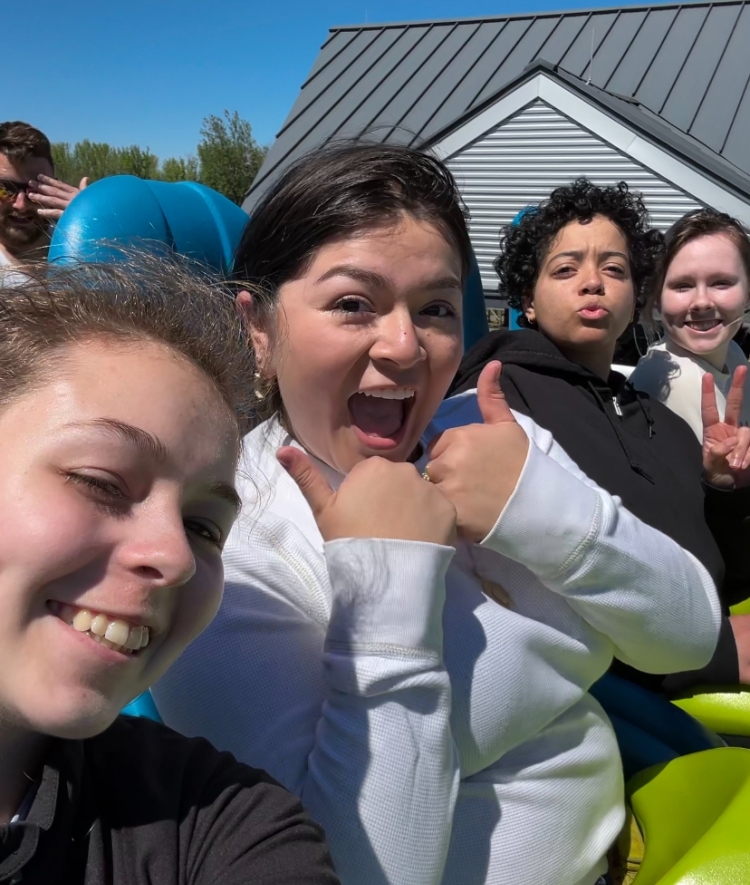 a group of students take a selfie together on a roller coaster ride