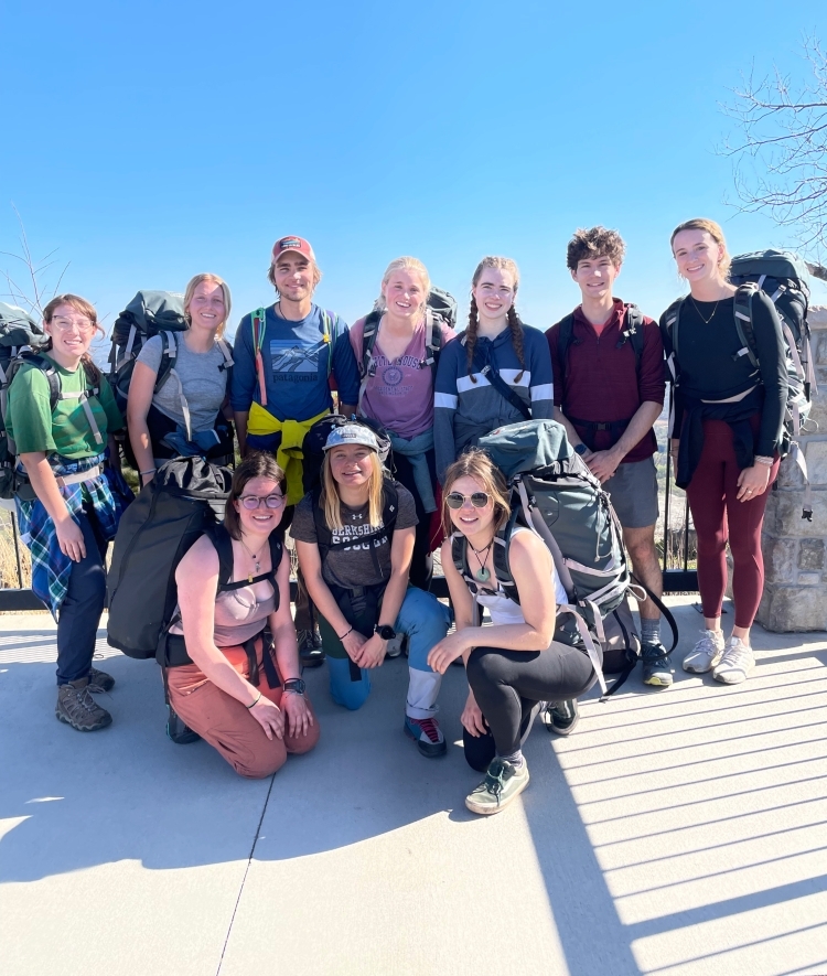 a group of students in hiking gear outside