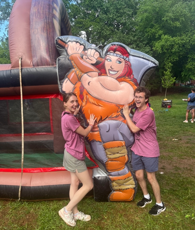 two young poeple stand with an inflatable outside