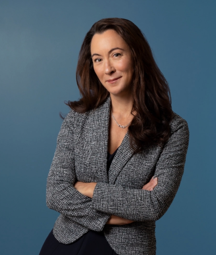 a young woman wearing a grey blazer