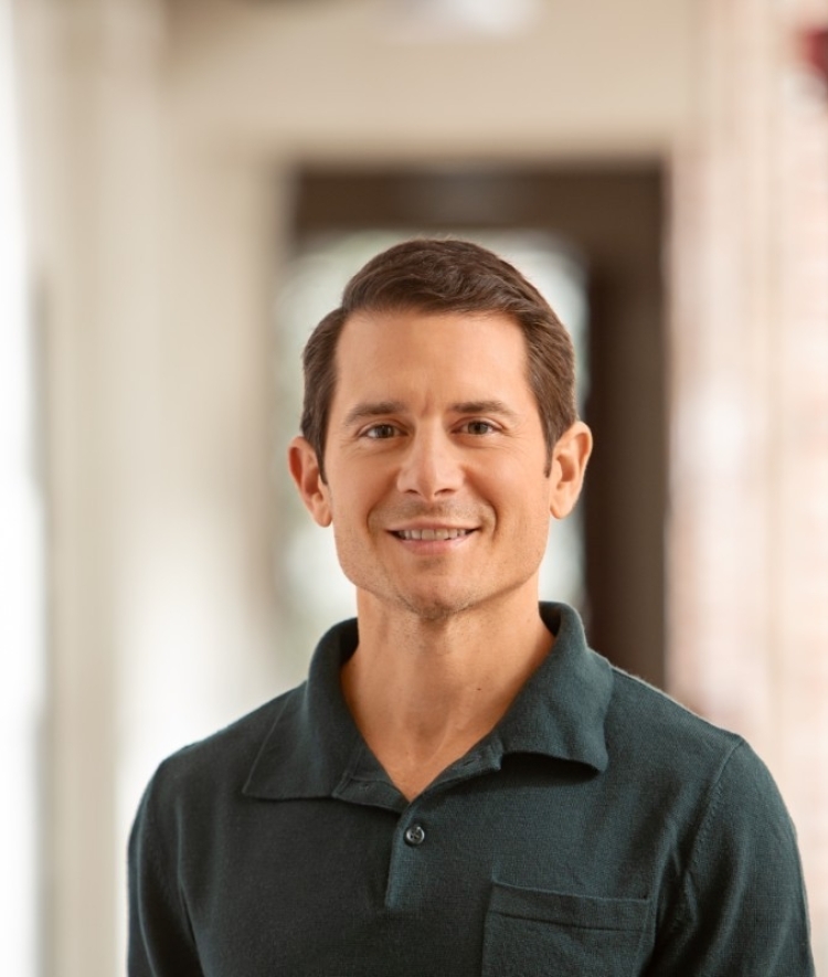 a middle aged white man wearing a green collared shirt