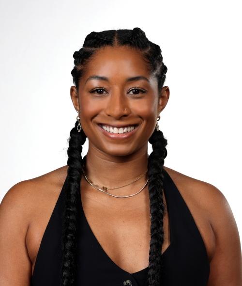 a young Black woman smiling with braids