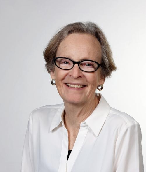 an older white woman wearing glasses and a white shirt