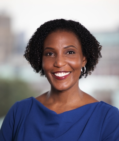 a middle aged Black woman wearing a blue top