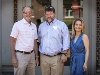 Scott Applegate, David Holthouser and Irsa Vargas pose on the steps of Chambers