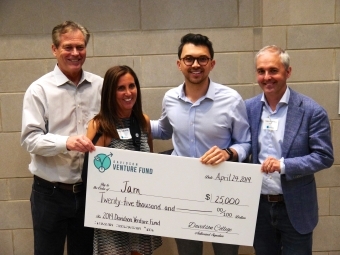 Shea Parikh and judges hold large check