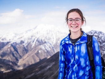 Catherine Cartier poses in front of mountain landscape