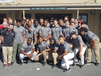 Football Team Poses for Photo at Naval Base