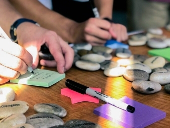 Students write on post it notes about mindfulness stones excercise