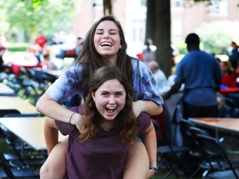 One student gives another a piggy-back ride