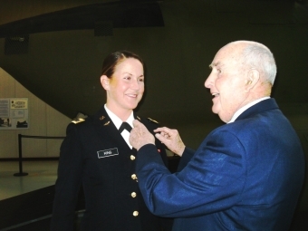 Alumnus Retired Air Force Brigadier General John Rose pins aviator wings on granddaughter Emily King 