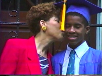 Family member kisses son on cheek, screenshot of documentary