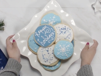 Person placing platter of cookies on a table 