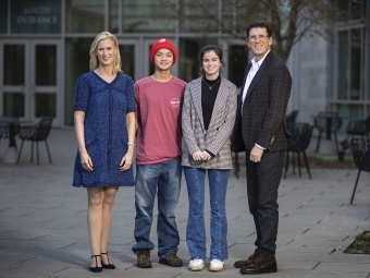 Scholars Michael Yen ’23 and Georgia Morris ’23  standing with scholarship founders Alison Hall Mauzé ’84 and Mike Mauzé ’85 in front of Wall building