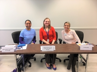 Alumni Elyse with two colleagues at support services table 