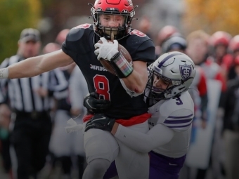 Davidson Football Player Clutching Ball While Running