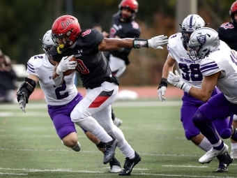 Davidson Football player takes off with ball