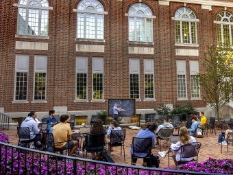 class being taught outdoors by Wall Academic Building