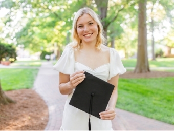 Siena Senn '22 holding graduation cap