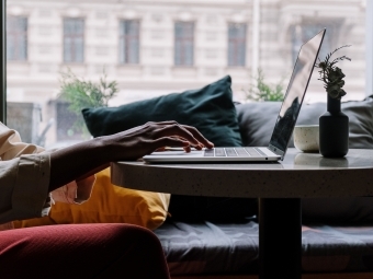 silhouette of hands on laptop