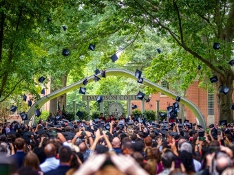 Graduation caps in air during ceremony