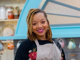 Karis Stucker '18 holding a whisk on the The Great American Baking Show