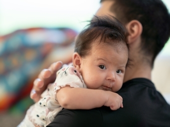 Baby on father's shoulder