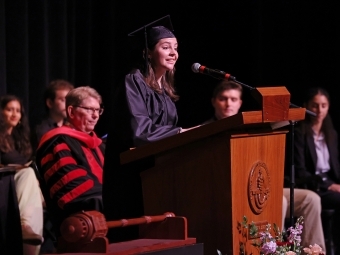 a young woman speaks at a podium 