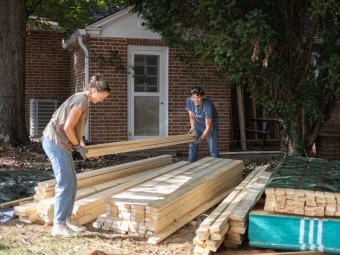 Students lifting lumber