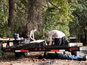 Students mounting tiny house on trailer