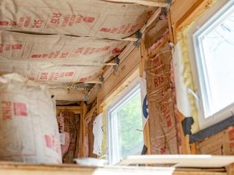 Exposed fiberglass insulation inside tiny house