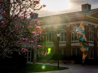 Campus Beauty Shonibare in front of building with sun shining