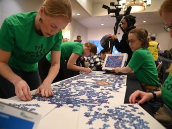 Becca Taylor ’06 and the Piece Corps working on a Mandala Puzzle