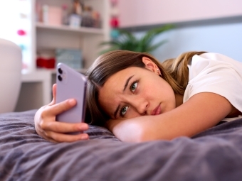 Teen sadly scrolling social media