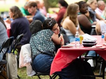 Two people hug at the orientation picnic