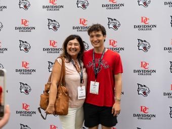 New student and woman pose for a photo at the orientation picnic