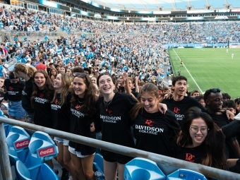 Student linking arms at Charlotte FC game