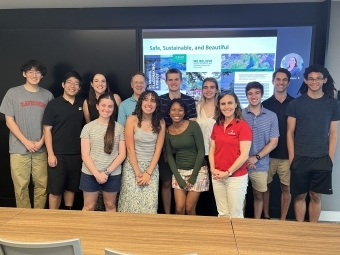 a group of students and adults together in a conference room